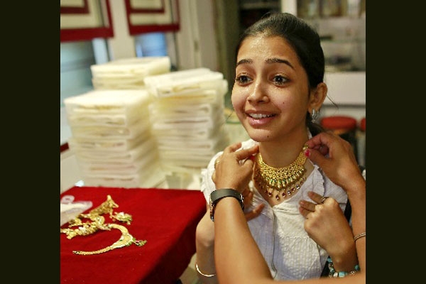 Gold ticks up in volatile trade bullion premiums steady